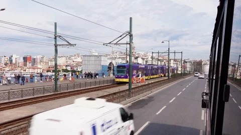 View from bus window on city bridge with public transport, tram, passing cars Stock Footage 241284781