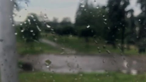 View from the bus window with drops on the glass, against the background of Stock Footage 131548768