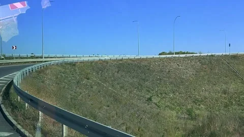 View from bus window on mountain, fence, bumper, highway, track, road, tree Stock Footage 298702127