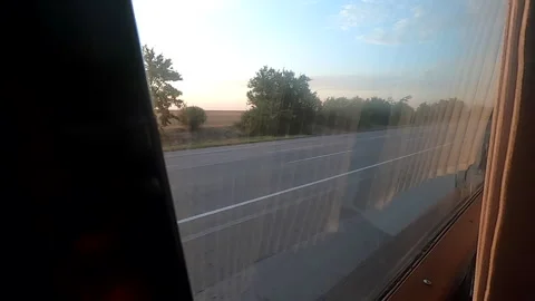 View from bus window View fields trees blue sky road through curtains moving bus Stock-Footage 303037413