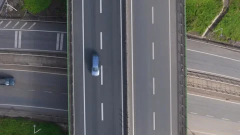 View of busy highway intersection with cars traveling on multiple lanes in dayti Stock Footage 301803930