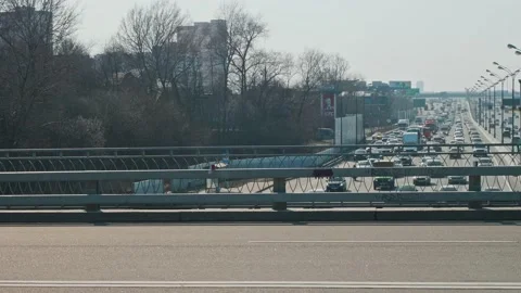 View of busy road from empty bridge. People ride bicycles on bridge. Stock Footage 153128593
