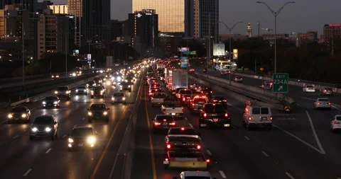 View of busy stop-and-go downtown city highway traffic during evening drive-time Stock Footage 146051434