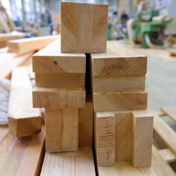 View from butt of stack of three-layer wooden glued laminated timber beams fr 스톡 사진