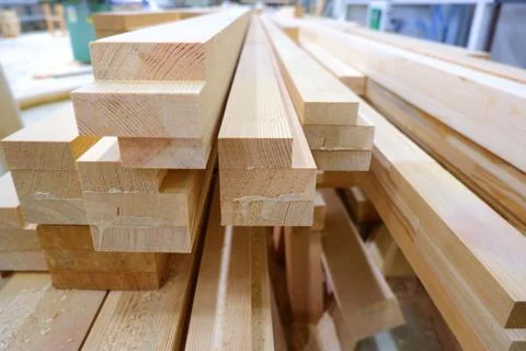 View from butt of stack of three-layer wooden glued laminated timber beams fr Stock-Fotos