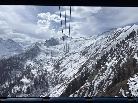 View from the cab of a cable car in the Alps, on a glacier in spring. Parti.. Stock Photos