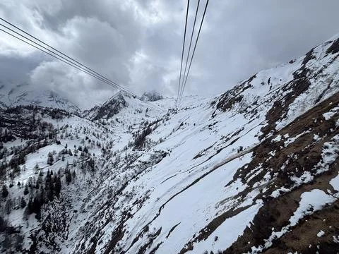 View from the cab of a cable car in the Alps, on a glacier in spring. Parti.. Stock Photos