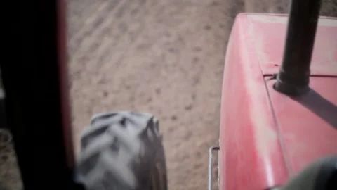 View from the cab of the tractor working in the field. The farmer is cultivating Stock Footage 224952897