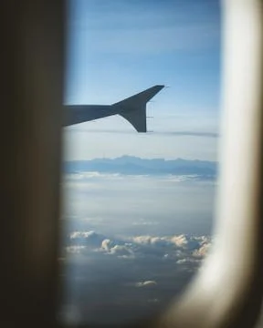 View from cabin of airplane.Through the window. Plane photography above clouds Stock Photos