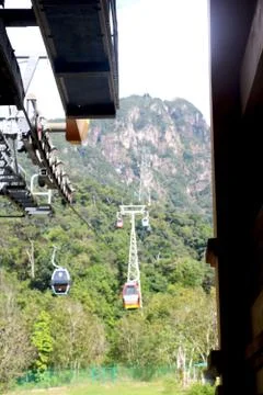 View of cable car from cable car station going up toward hill Stock Photos