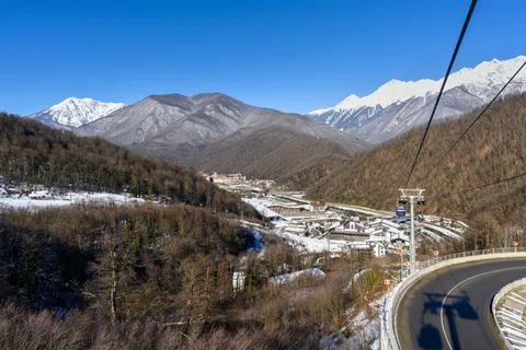 A view from a cable car descending through snow-covered trees with a mounta.. Stock Photos