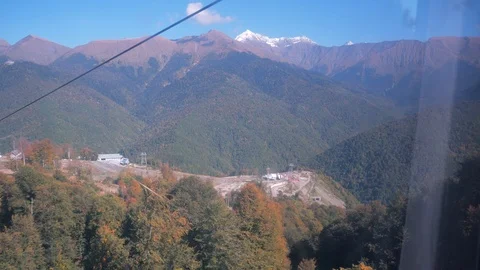 View from cable car on mountain slope covered with autumn trees Video stock 105177874