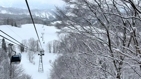 View from cable car moving over snowy mountains Stock Footage 237241632