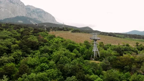 View on the cable car with a rising funicular, mountains and green forest Stock Footage 170378966