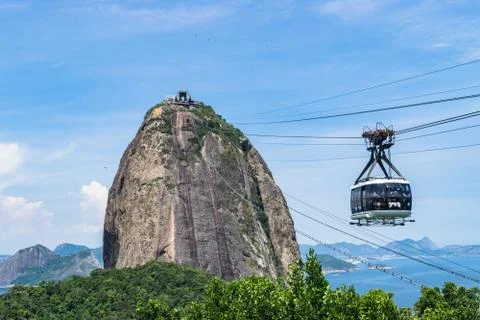 View of a cable car at sunset, showing several beaches and landmarks in Rio de Stock Photos