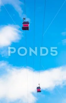 View of cableway gondola cable car on blue sky background Stock Photos