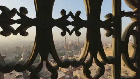 View of Cairo city and Mosque of Sultan Hassan through iron bars of window. View Video stock 166566463