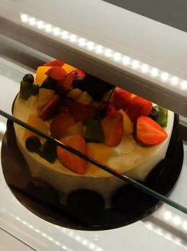 View of a cake in shop display unit in the market 스톡 사진