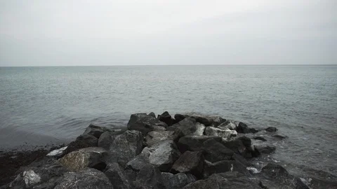 A view on a calm Baltic Sea, with the waves splashing on the rocks. Stock Footage 86560502