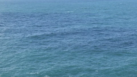 A view of calm blue ocean water with gentle ripples and waves. Stock Footage 296780020