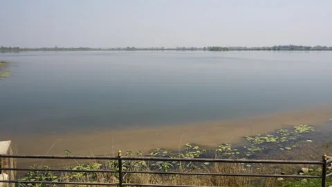 View of a calm lake with a water control gate, Nepal. Stock Footage 335604362