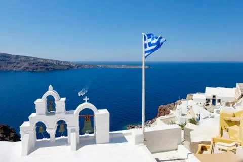 View on calm sea surface through traditional Greek white church arch Stock Photos
