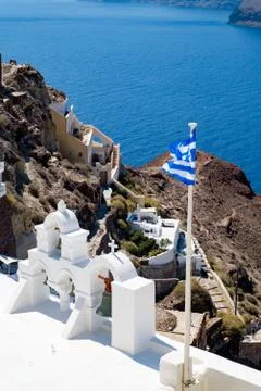 View on calm sea surface through traditional Greek white church arch Stock Photos