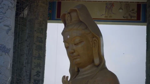View of Camera pan from head to toe of Guan Yin Goddess statue Stock Footage 120399999