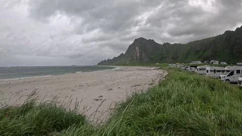 View of camper van parking along Bleik beach with dramatic mountains in Norway 库存影片 343130616
