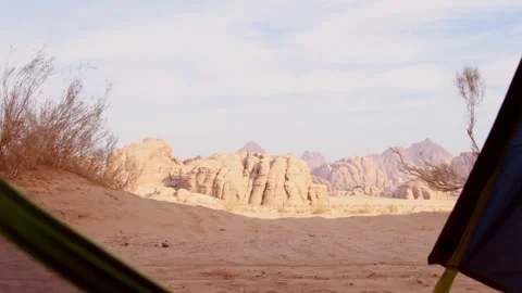 View from camping tent in Wadi rum toward sandstone mountains and sandy des.. Stock Footage 330424360