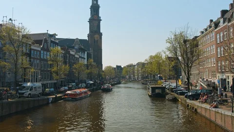 View of canal in Amsterdam with tower Westerkerk on the background Stock Footage 119962553