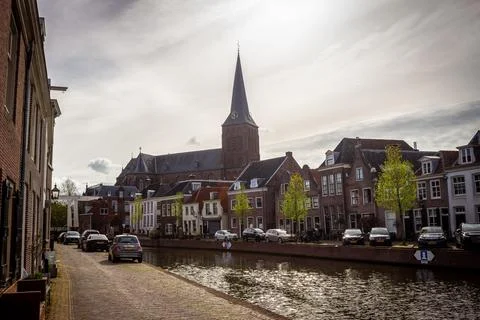 View of canal Maarssen-Dorp on spring day with church Stock Photos