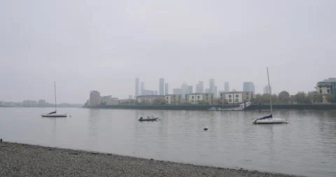 View of Canary Wharf from a Beach on the River Thames on an Overcast Day Stock Footage 291130157