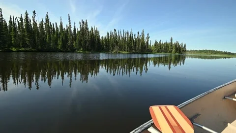 View from a canoe drifting along a calm park dark blue lake Stock Footage 140273580