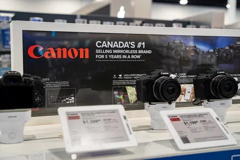 View of Canon mirrorless cameras on electronics store display. Toronto, Canada - Stock Photos