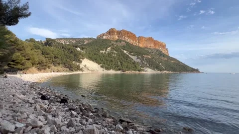 View of Cap Canaille cliff from rocky beach. Cap Canaille, Cote d'Azur, France Stock Footage 244269013
