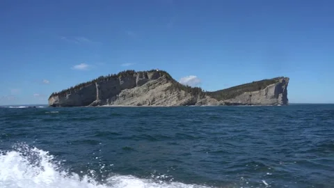 View of Cap Gaspe lighthouse from moving boat Stock Footage 143208101