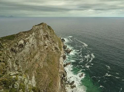 View from Cape point to the lighthouse on cloudy day near Cape of Good Hope Stock Photos