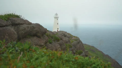A view of the Cape Spear lighthouse against a fog shrouded Atlantic Ocean Stock Footage 284682494
