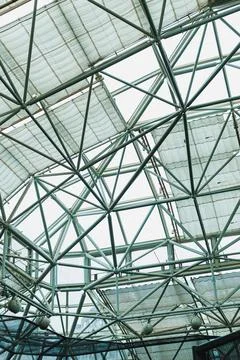 The view captures the framework of a contemporary building. Metal beams and f Stock Photos