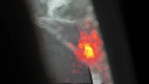 View from the car to the car ahead through the glass covered with raindrops Stock Footage 204991379