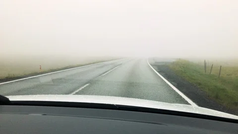 View from car dashboard driving in fog and misty weather Stock Footage 104127853
