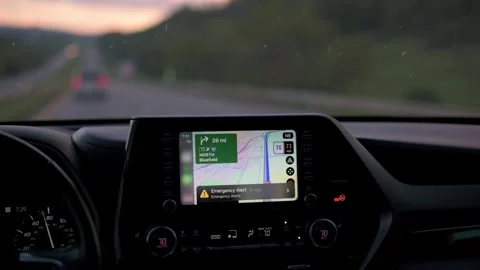 View of car dashboard showing GPS navigation system during highway drive at dusk Stockbeeldmateriaal 293121908
