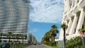 View from car driving big city street, passing hotels and apartment buildings HD Footage