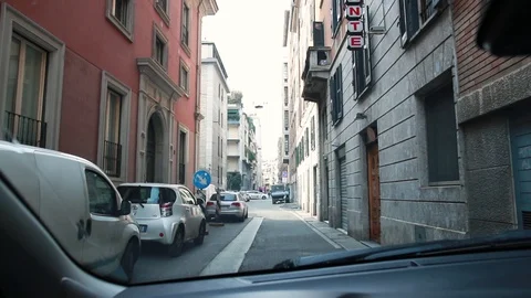 View from a car driving through a narrow street in the city Stock Footage 128732552