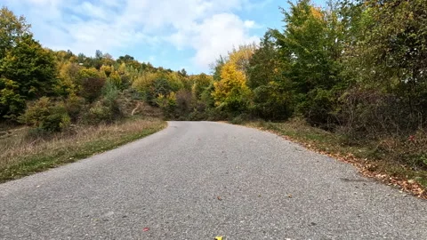 View from the car driving on a winding mountain road in autumn. Video stock 231996754