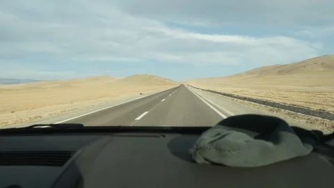 View from car on an empty picturesque mountain road in Mongolia on highway Stock Footage 127953904