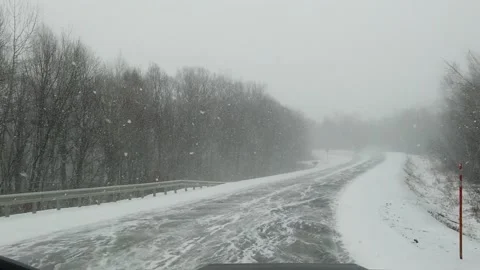 View from car to heavy snowfall on road in Russia slow motion video Video stock 144643623