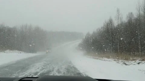 View from car to heavy snowfall on road in Russia slow motion video Stock-Footage 145641416