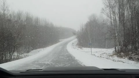 View from car to heavy snowfall on road in Russia slow motion video Stock-Footage 146159218